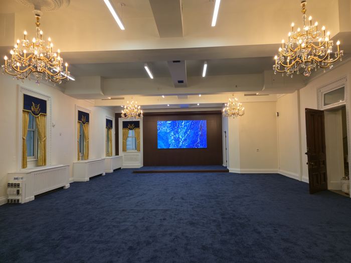 The same hall after renovation, with new carpet, lighting and finishes