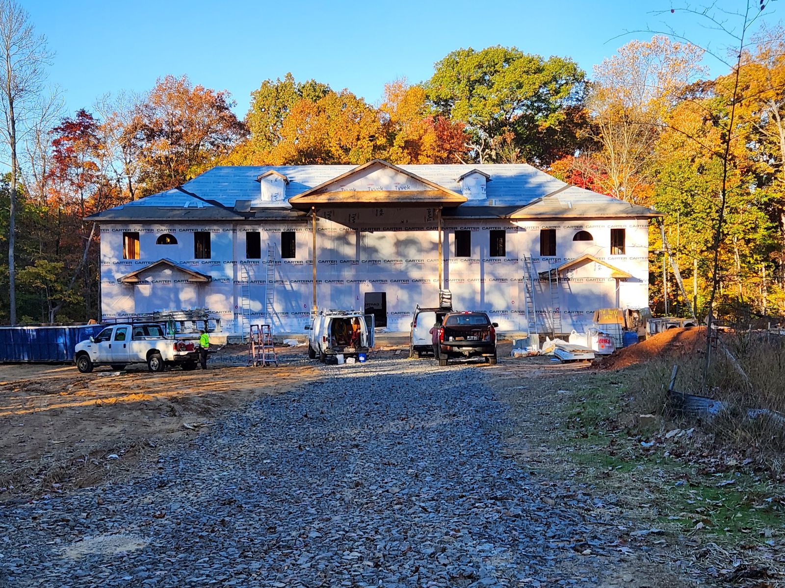 Active construction site with crew, vehicles and staged materials
