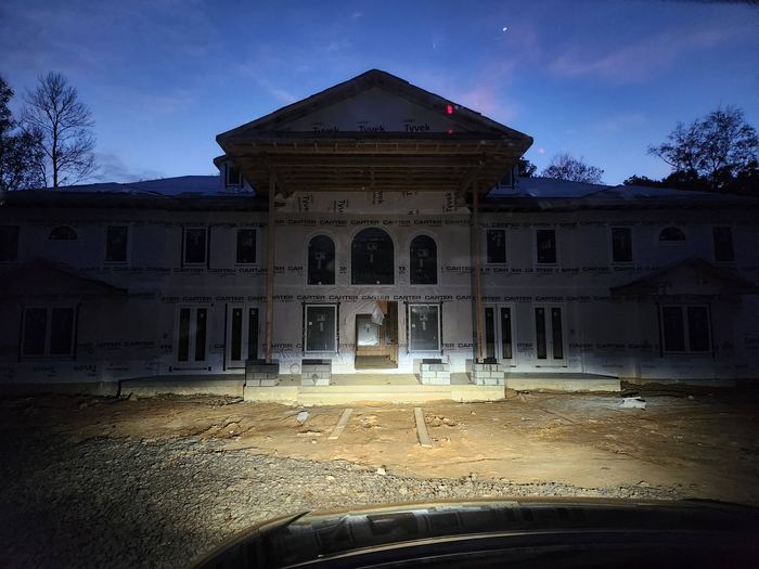 Front elevation at dusk during construction