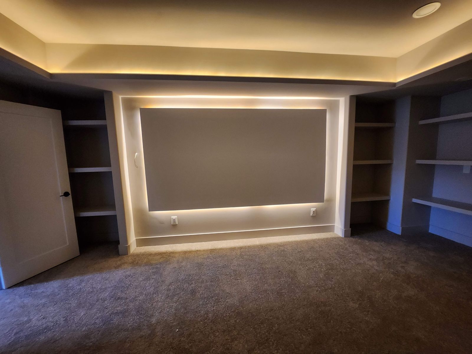 Finished interior room with coffered ceiling detail and built-in joinery