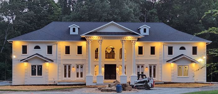 Completed residence illuminated at dusk