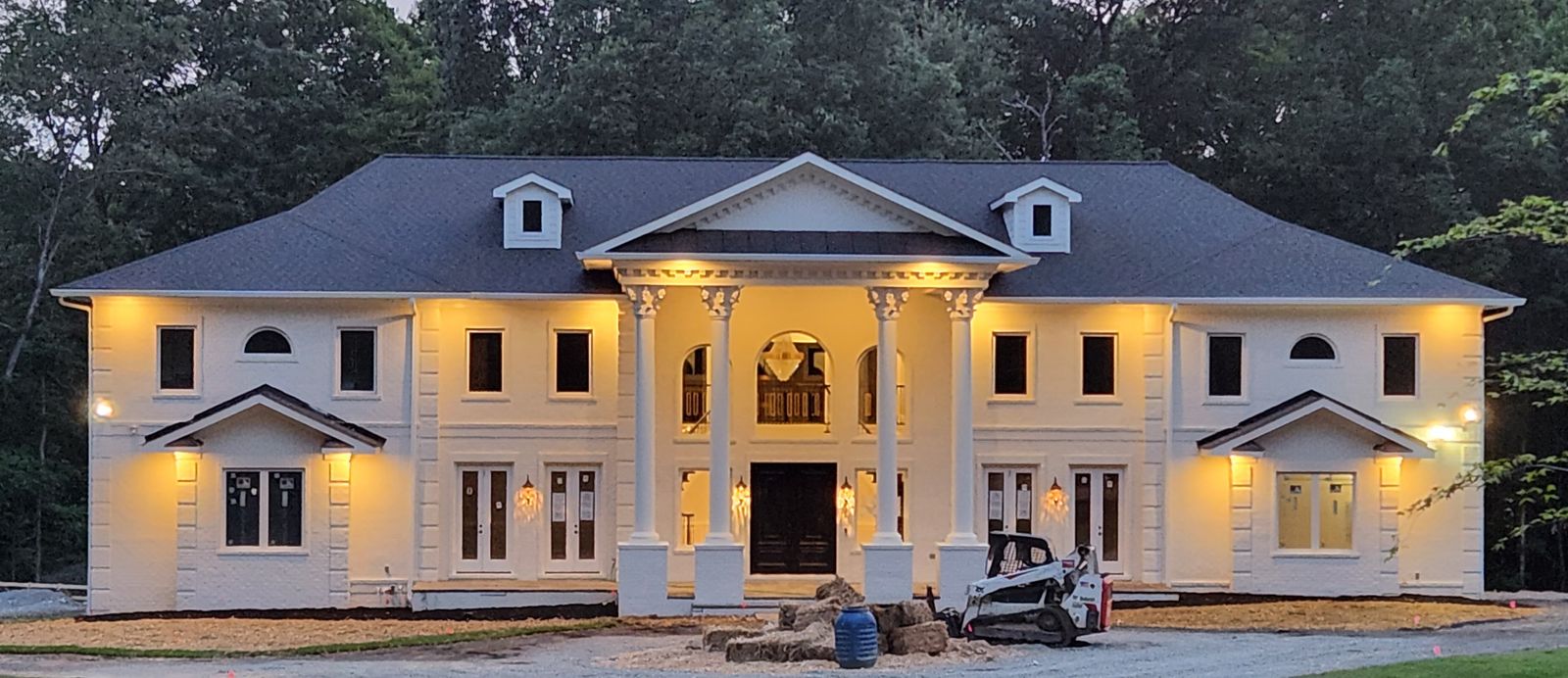 Completed residence illuminated at dusk