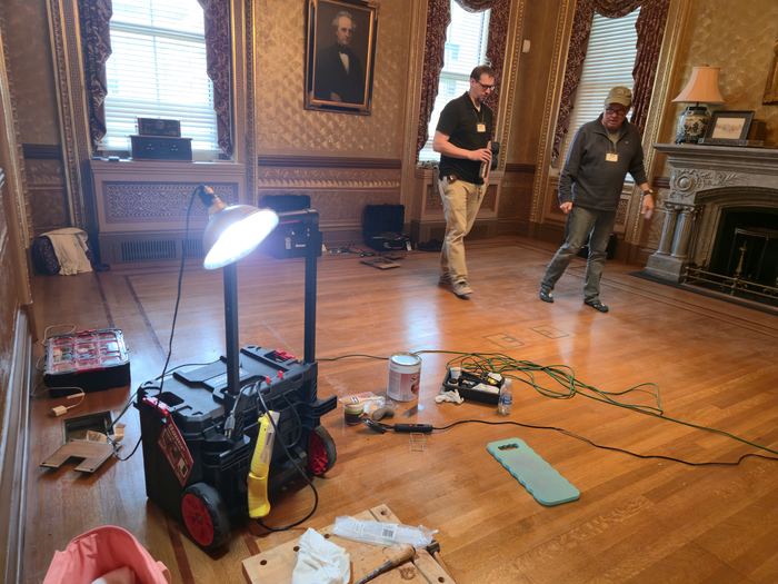 Floor sanding and refinishing in progress with site equipment in place