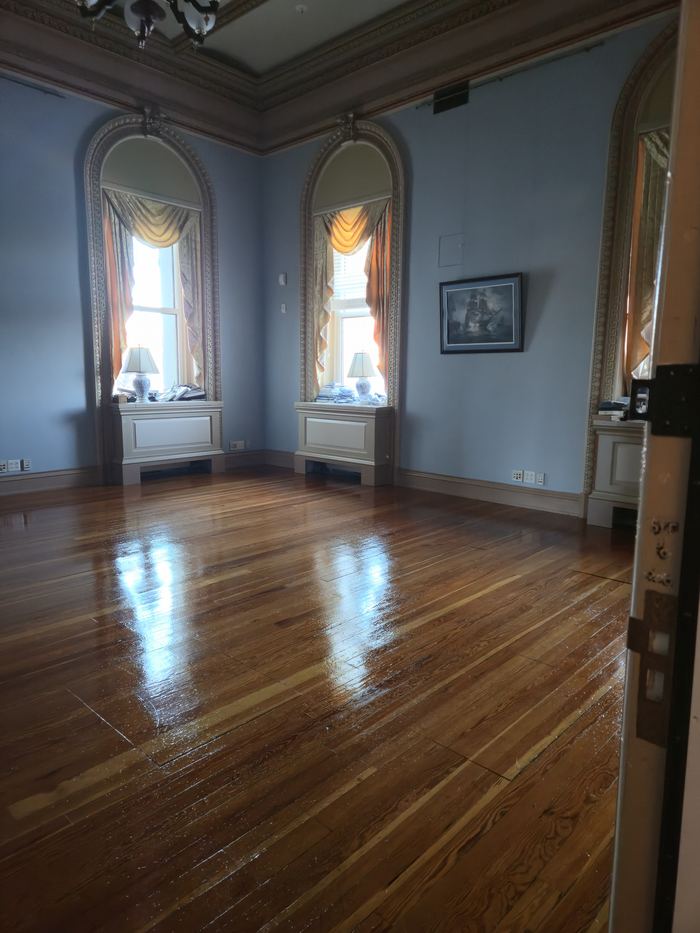 Restored hardwood flooring in a panelled historic room