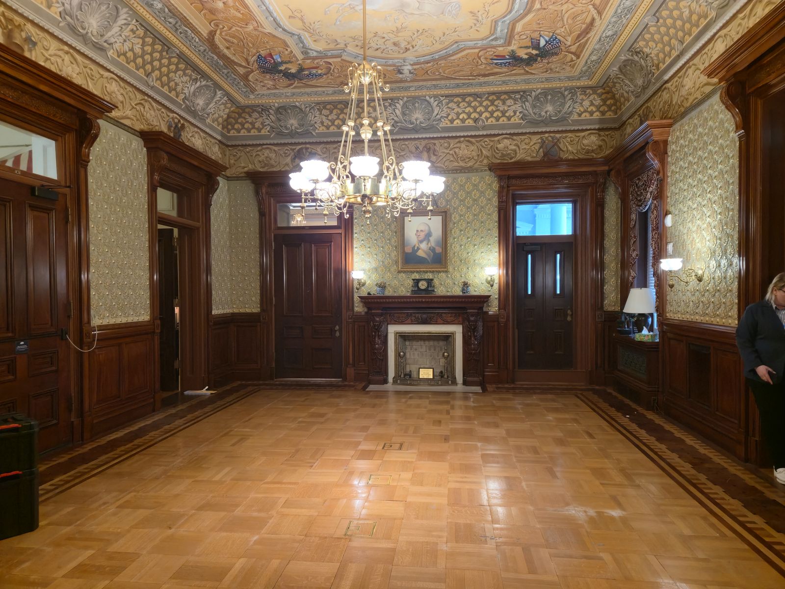 Restored hardwood flooring in a wood-panelled historic room
